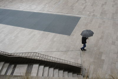 High angle view of woman walking on staircase