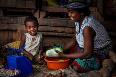 Portrait of a smiling girl sitting outdoors