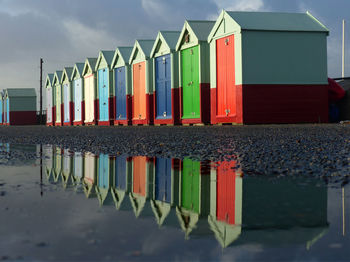 Multi colored umbrellas on beach against sky