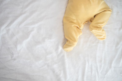 High angle view of person lying on bed