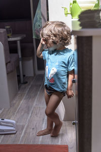 Rear view of girl sitting on floor