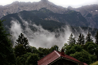 Panoramic view of building and mountains against sky