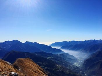 Scenic view of mountains against clear blue sky