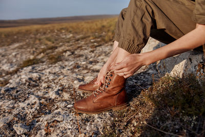 Low section of man standing on field