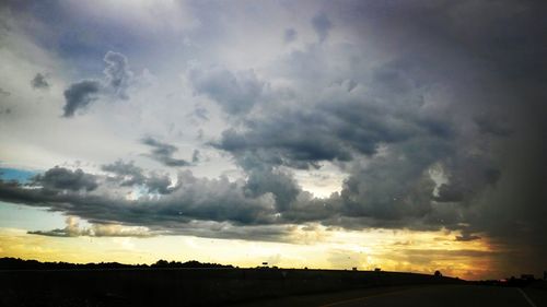 Scenic view of dramatic sky over field