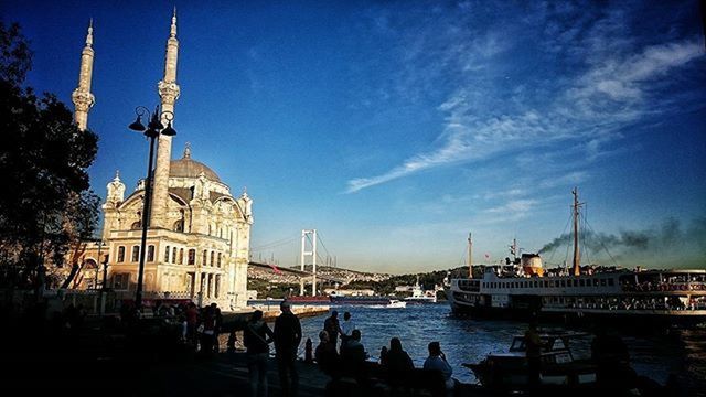 architecture, built structure, building exterior, water, sky, blue, city, travel destinations, nautical vessel, famous place, river, travel, tourism, dome, tower, transportation, large group of people, church, place of worship