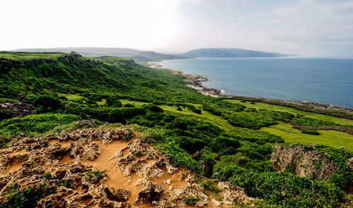 Scenic view of sea and mountains against sky