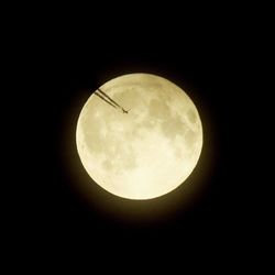 Low angle view of moon against sky at night