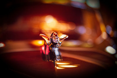 Close-up of lit candle on table