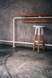 Close-up of empty seats on table against wall in building