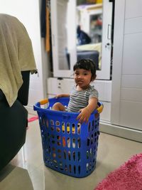 Rear view of woman standing in container