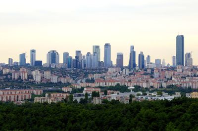 Buildings in city against clear sky