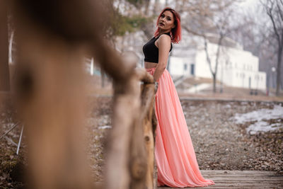 Portrait of young woman standing outdoors