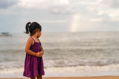 Full length of woman standing on beach