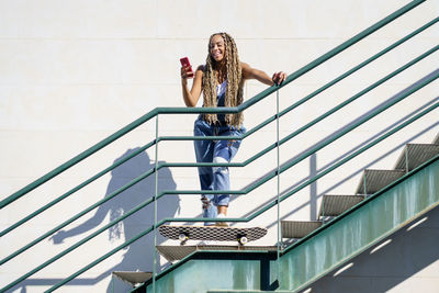 Low angle view of woman on staircase