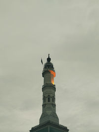 Low angle view of statue of historic building against sky