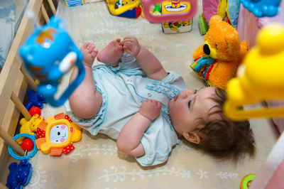 High angle view of cute baby girl sitting on table