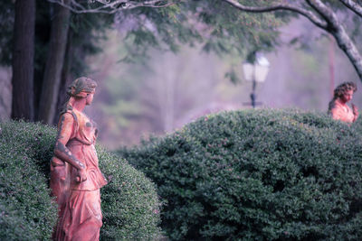 Woman standing in forest