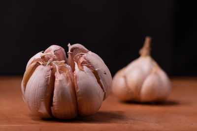 Close-up of bread on table against black background