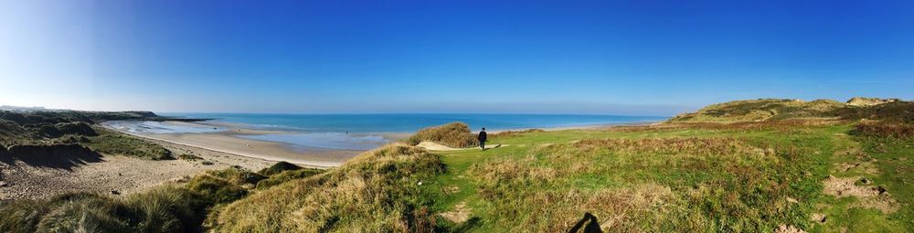 Panoramic view of sea against clear blue sky