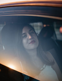 Portrait of woman in car through the window