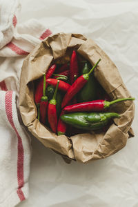 Jalepenos and chili peppers in brown paper sack