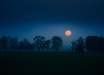 A summer sun rising in a very hazy morning with lots of dust particles in the air. misty sunrise. 