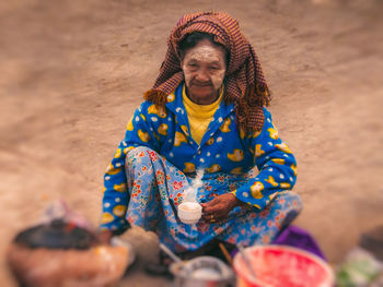 Portrait of smiling woman sitting on beach