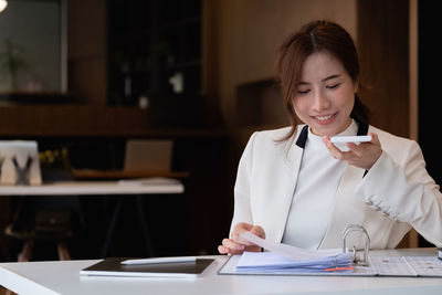 Mid adult woman working at table