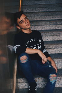 Portrait of young man sitting on seat