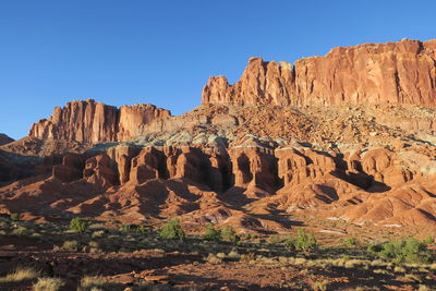 Rock formations in desert against blue sky