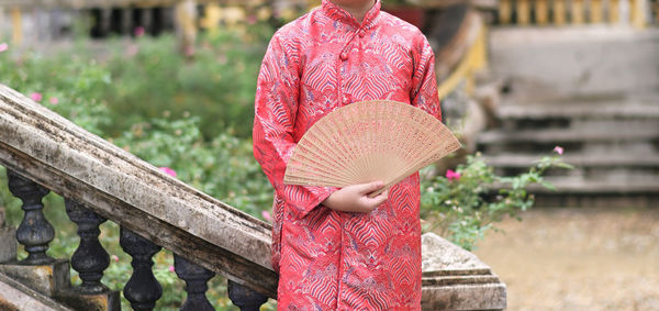 Little boy in red silk traditional ao dai of vietnam