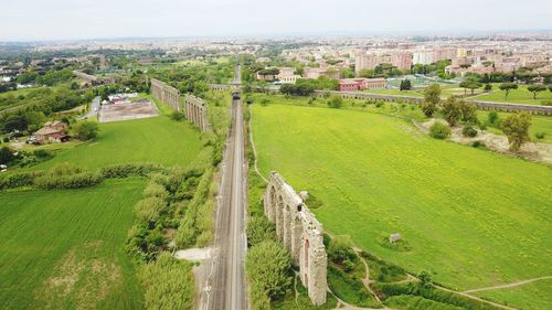 High angle view of buildings on field against sky