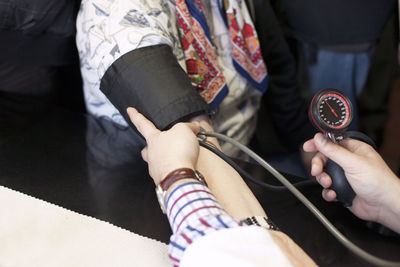 Cropped image of doctor examining patient blood pressure in hospital