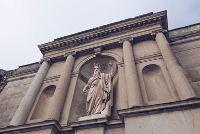 Low angle view of statue against building