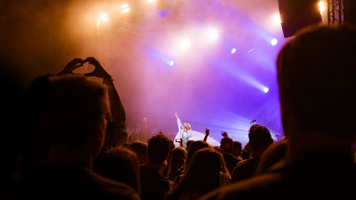 People enjoying music concert at night