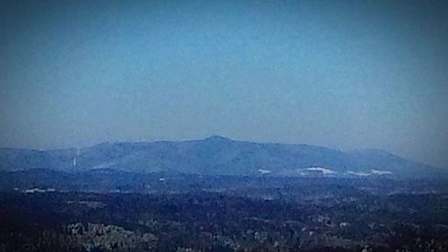 Scenic view of mountains against clear blue sky