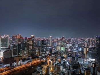 High angle view of illuminated city buildings against sky