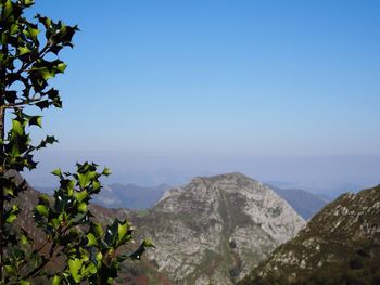 Scenic view of mountains against clear blue sky