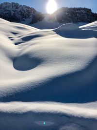 Scenic view of snow covered land against sky