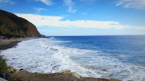 Scenic view of sea against cloudy sky