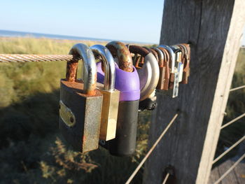 Close-up of padlocks hanging on railing