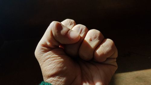 Close-up of human hand clenching fist