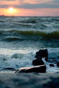 Close-up of sea against sky during sunset