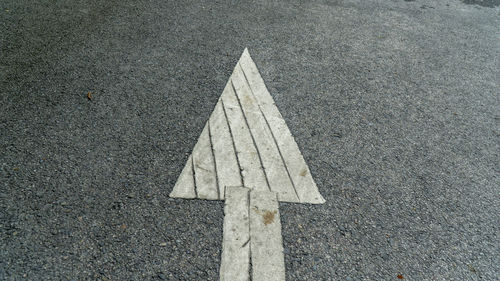 High angle view of arrow symbol on road