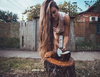 Beautiful young woman in back yard