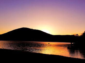 Scenic view of lake against romantic sky at sunset