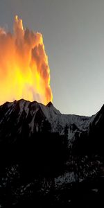 Scenic view of volcanic mountain against sky during sunset