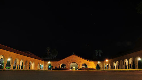 Illuminated temple against clear sky at night