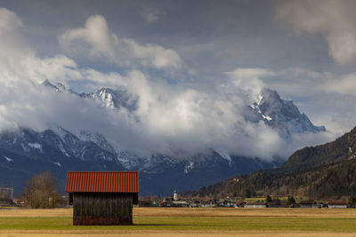 Scenic view of field and mountains against sky